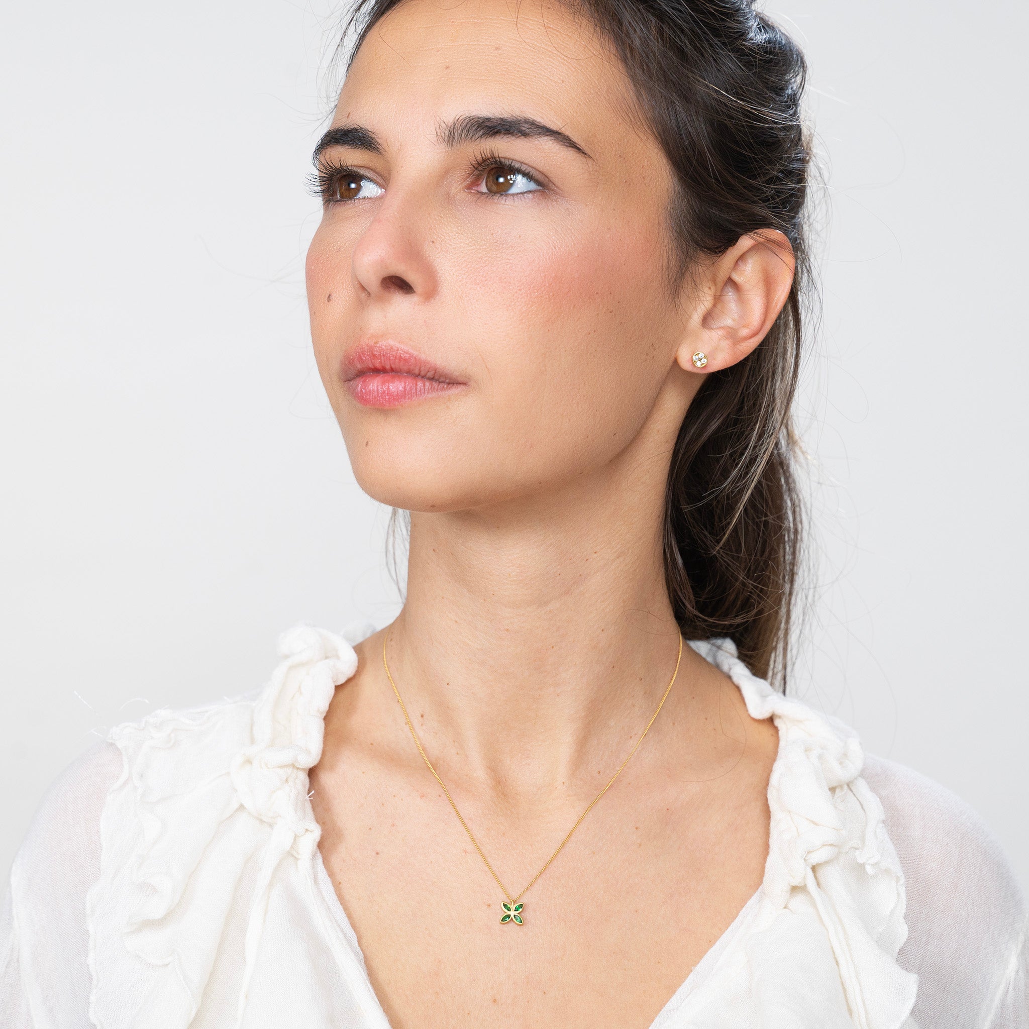 Model beautifully wearing the Gold Spring Flowers pendant, with marquise-cut emeralds forming an intricate flower, enhancing any outfit with a luxurious touch of spring.