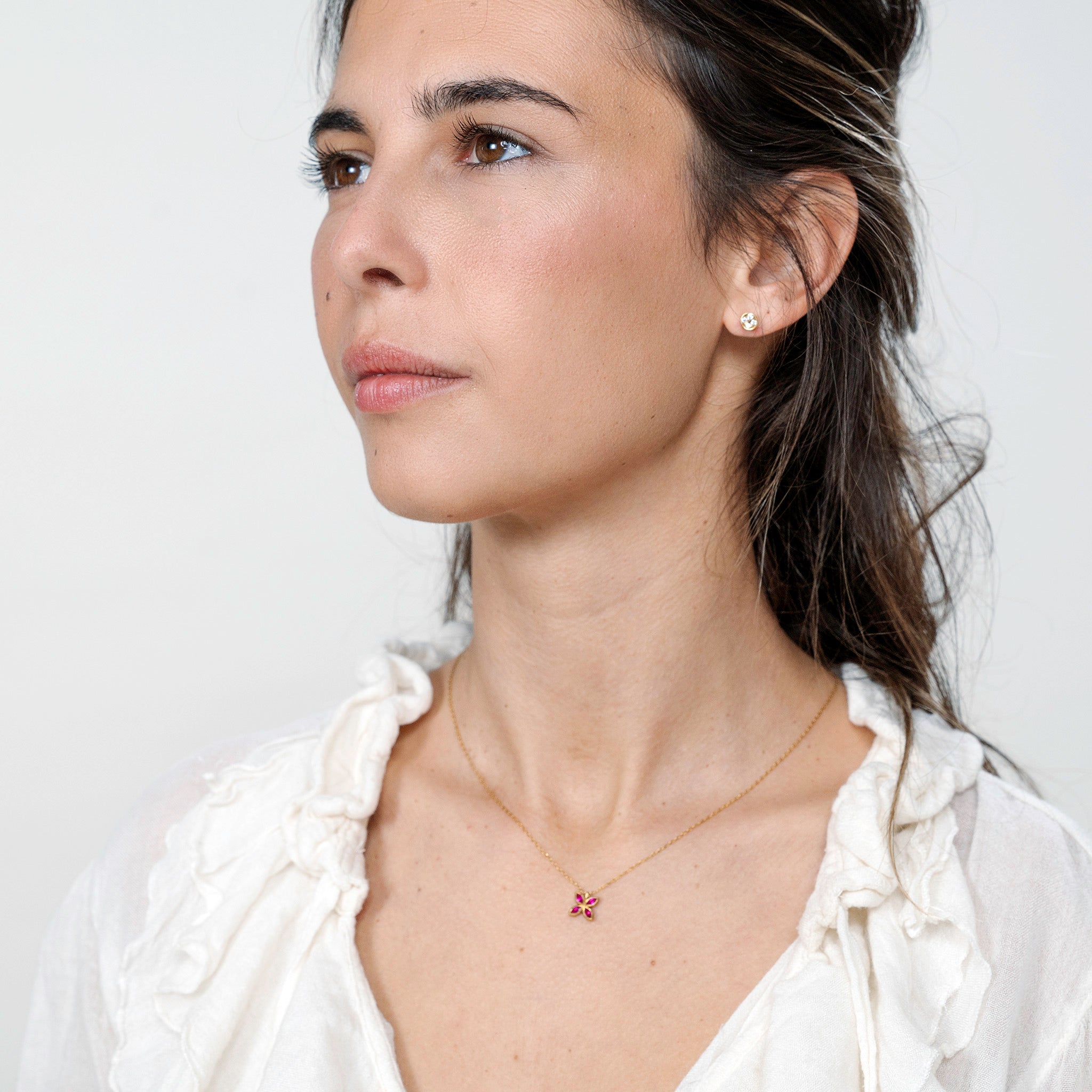 Model beautifully wearing the Gold Spring Flowers pendant, with marquise-cut Rubies forming an intricate flower, enhancing any outfit with a luxurious touch of spring.